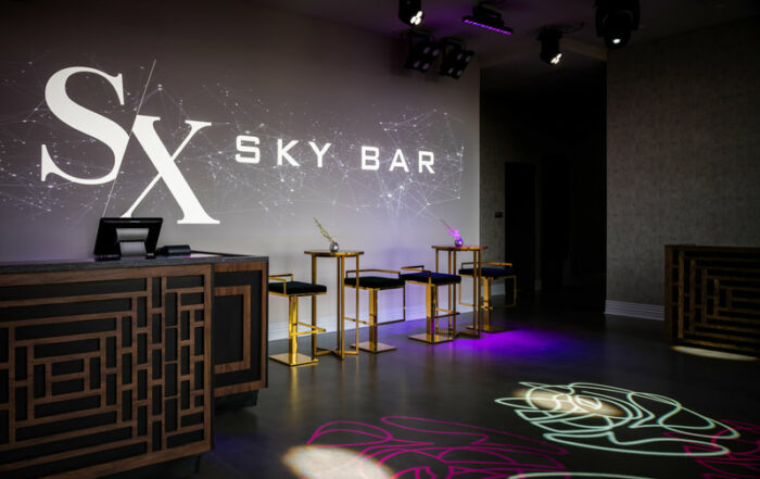 SX Sky bar logo projected on entry area