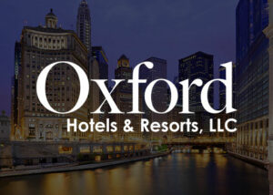 The Oxford Hotels & Resorts logo appears overtop an image of a city skyline at night