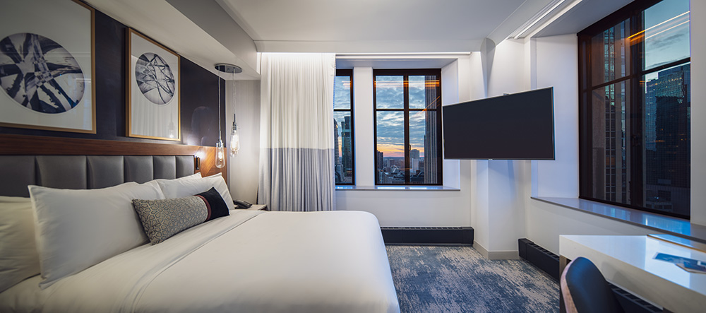 Luxury hotel room with window views of the skyline